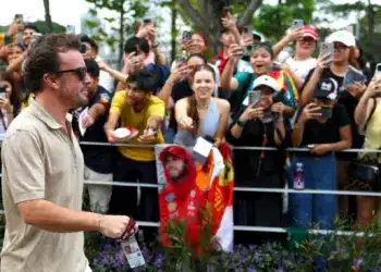 Fernando Alonso épp elsétál egy sor rajongó előtt